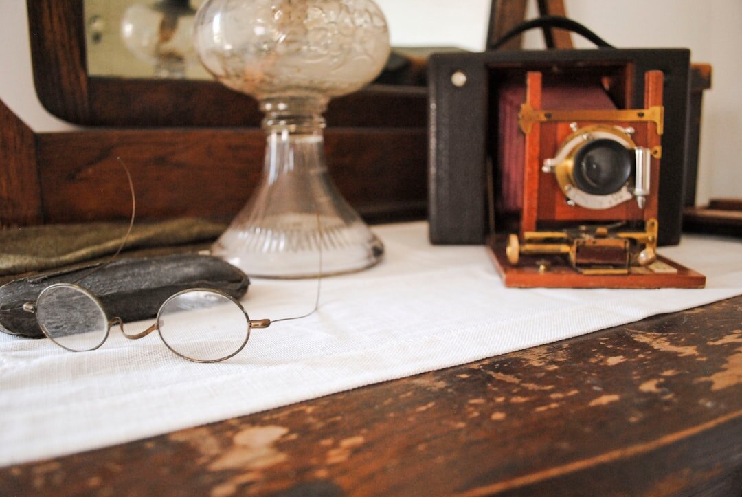 Old photographs, film reels and magazine clippings scattered on a wooden archive table