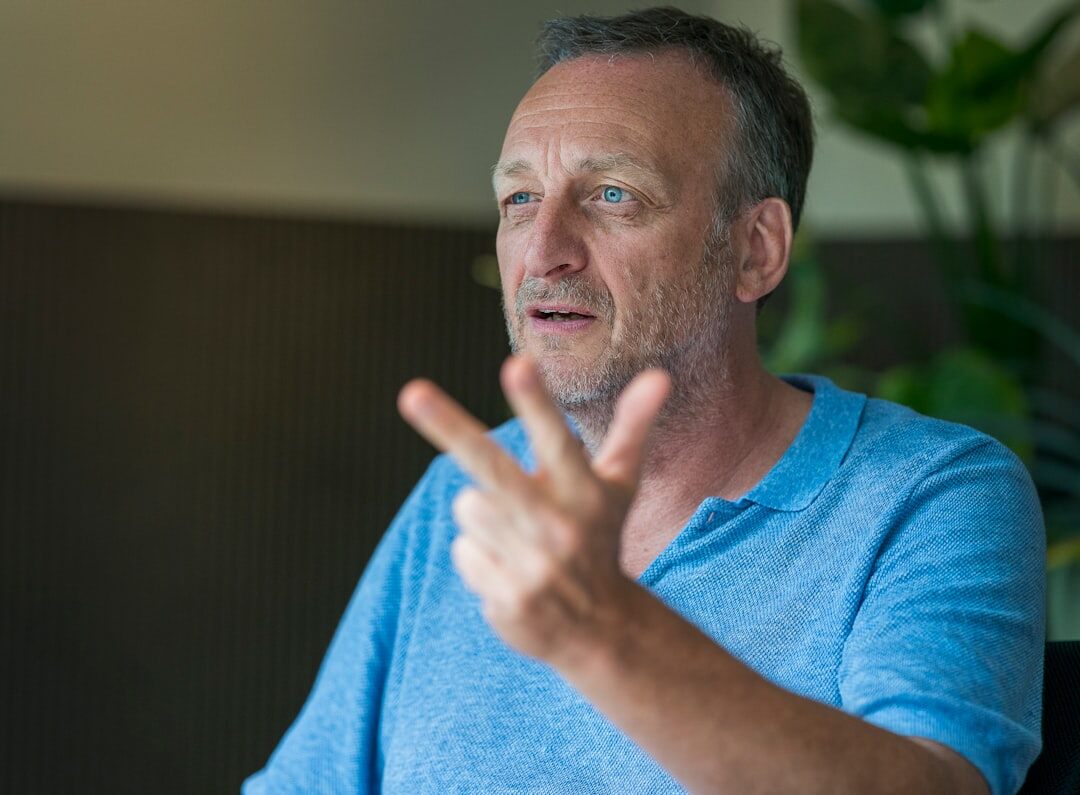 Friendly Uruguayan man in his forties posing for a television host portrait