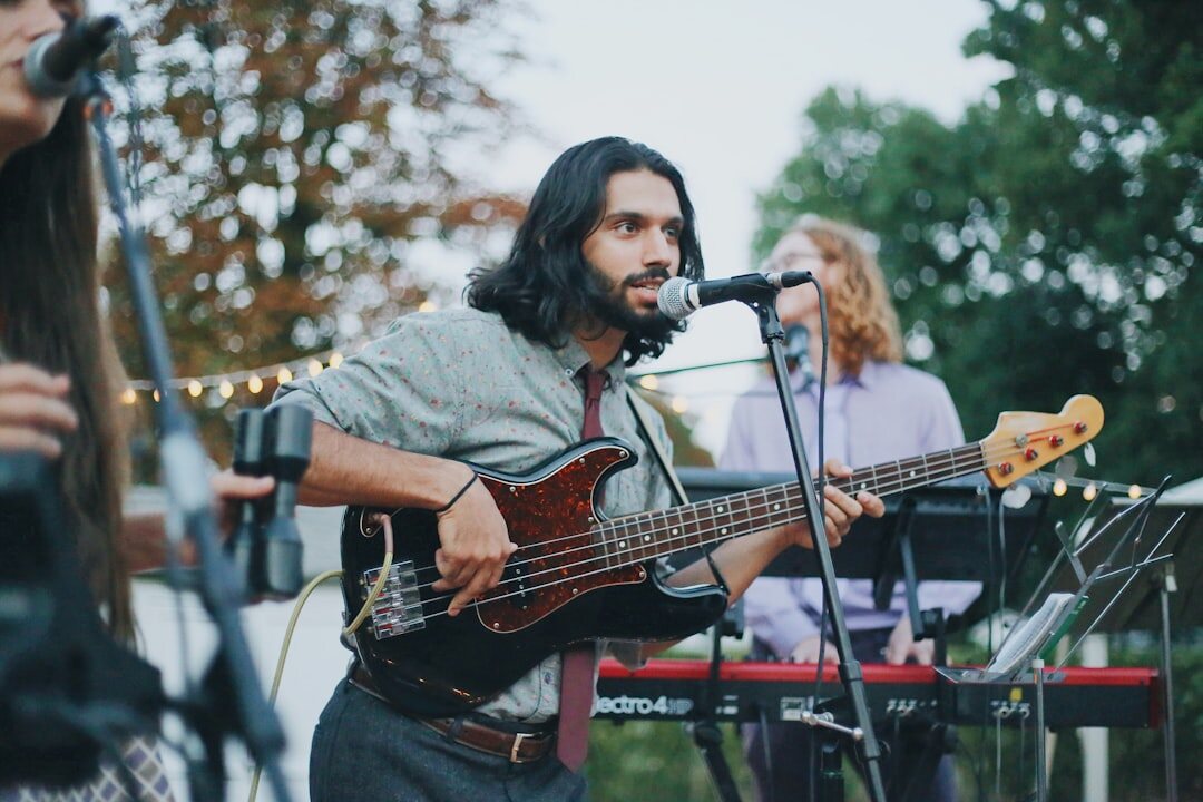 musician playing guitar on stage